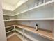 Spacious walk-in pantry with wooden countertops and white shelving at 165 Inspiration Way, Fuquay Varina, NC 27526
