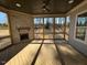 Cozy screened porch with a stone fireplace and wood flooring at 165 Inspiration Way, Fuquay Varina, NC 27526