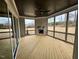 Cozy sunroom with fireplace, wood floors, and serene outdoor views at 165 Inspiration Way, Fuquay Varina, NC 27526