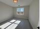 Bright bedroom with a large window and carpeted floor at 183 Inspiration Way, Fuquay Varina, NC 27526