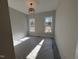Well-lit bedroom featuring two windows at 183 Inspiration Way, Fuquay Varina, NC 27526