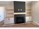 Modern fireplace with built-in shelving and cabinetry at 183 Inspiration Way, Fuquay Varina, NC 27526