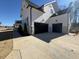Two-car garage with black doors and light-colored concrete driveway at 183 Inspiration Way, Fuquay Varina, NC 27526