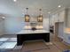 Spacious kitchen with large island, stainless steel appliances, and white cabinets at 183 Inspiration Way, Fuquay Varina, NC 27526