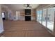 Open living room featuring a fireplace, built-in shelving, and sliding glass doors at 183 Inspiration Way, Fuquay Varina, NC 27526