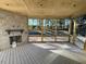 Relaxing screened porch with stone fireplace and wood flooring at 183 Inspiration Way, Fuquay Varina, NC 27526