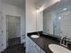 Bathroom with double vanity, modern lighting, and walk-in closet at 189 Waterwheel Dr, Selma, NC 27576