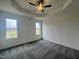 A spacious room with large windows that let in natural light and plush carpeting at 189 Waterwheel Dr, Selma, NC 27576