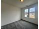 A well-lit room with a large window that lets in natural light and plush carpeting at 189 Waterwheel Dr, Selma, NC 27576