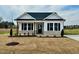 Charming single-story home featuring black shutters, brick accents, and a welcoming front porch at 189 Waterwheel Dr, Selma, NC 27576