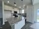 Bright kitchen featuring stainless appliances, ample counter space, hardwood floor, and a central kitchen island at 189 Waterwheel Dr, Selma, NC 27576