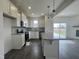 Bright kitchen featuring stainless appliances, ample counter space, hardwood floor, and a central kitchen island at 189 Waterwheel Dr, Selma, NC 27576