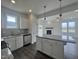 Open kitchen flowing into a living room with a fireplace and access to the backyard at 189 Waterwheel Dr, Selma, NC 27576