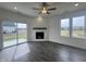 Bright living room featuring a fireplace, large windows and access to the backyard at 189 Waterwheel Dr, Selma, NC 27576