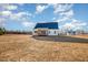 House with backyard, showcasing a large grassy area at 35 Uptown Rd, Zebulon, NC 27597