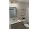 Bathroom with single vanity, quartz countertop, and a tub at 35 Uptown Rd, Zebulon, NC 27597
