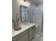 Bathroom vanity featuring double sinks, sleek fixtures, and a separate glass-enclosed shower at 35 Uptown Rd, Zebulon, NC 27597