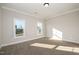 Bright bedroom with neutral walls and carpet flooring at 35 Uptown Rd, Zebulon, NC 27597