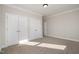 Spacious bedroom with double doors and ample closet space at 35 Uptown Rd, Zebulon, NC 27597