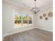 Bright dining area features modern flooring, neutral paint, and contemporary chandelier at 35 Uptown Rd, Zebulon, NC 27597