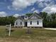 Charming two-story home with white and grey siding and a well-manicured lawn at 35 Uptown Rd, Zebulon, NC 27597