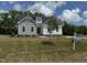 Charming two-story home with white and grey siding and a well-manicured lawn at 35 Uptown Rd, Zebulon, NC 27597