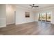 Spacious living room with modern flooring, neutral paint, a fan, and glass patio doors at 35 Uptown Rd, Zebulon, NC 27597