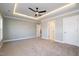 Large primary bedroom featuring tray ceilings, neutral walls, and ample space at 35 Uptown Rd, Zebulon, NC 27597