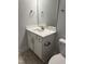 Modern vanity with white countertops, cabinetry, and sleek bronze hardware in a well-lit bathroom at 120 Watermelon Dr, Franklinton, NC 27525