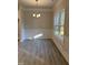 Bright dining room with large windows, wood floors, chair rail, and stylish chandelier at 120 Watermelon Dr, Franklinton, NC 27525