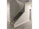 Staircase with carpeted steps and wrought iron railing at 120 Watermelon Dr, Franklinton, NC 27525