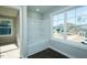 Bathroom with shower and tub features a large window with backyard views at 121 Ambergate Ct, Rocky Mount, NC 27804