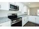 Kitchen with stainless steel appliances, white cabinets, and granite countertops at 121 Ambergate Ct, Rocky Mount, NC 27804