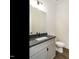 Modern bathroom features a gray countertop vanity, a white sink, and a toilet with a black faucet at 1535 Urban Trace Ln, Raleigh, NC 27608