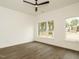 Minimalist bedroom with hardwood floors, natural light, and modern ceiling fan at 1535 Urban Trace Ln, Raleigh, NC 27608
