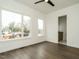 Modern bedroom with an ensuite bath features natural light and hardwood floors at 1535 Urban Trace Ln, Raleigh, NC 27608