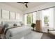 Stylish bedroom with large windows, neutral decor, and modern ceiling fan at 1535 Urban Trace Ln, Raleigh, NC 27608