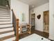 Inviting entryway featuring staircase, console table, and doorway to bath at 1535 Urban Trace Ln, Raleigh, NC 27608