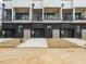 Modern townhome exterior with black brick, screened balconies, and individual garage entrances at 1535 Urban Trace Ln, Raleigh, NC 27608
