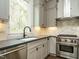 Modern kitchen featuring stainless steel appliances, granite countertops, and a marble backsplash at 1535 Urban Trace Ln, Raleigh, NC 27608