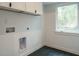 Clean laundry room with modern fixtures and black hexagon tile flooring at 1535 Urban Trace Ln, Raleigh, NC 27608