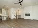 This open floor plan includes an eat-in kitchen and living area with sleek, modern fireplace at 1535 Urban Trace Ln, Raleigh, NC 27608