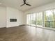 Spacious living room boasts a modern fireplace, hardwood floors and sliding doors to balcony at 1535 Urban Trace Ln, Raleigh, NC 27608