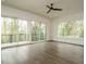 Bright living room offering lots of natural light, a balcony, and stunning hardwood floors at 1535 Urban Trace Ln, Raleigh, NC 27608