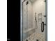 Modern shower with a glass door, a built-in shower bench, and a gray hexagonal tile floor at 1535 Urban Trace Ln, Raleigh, NC 27608