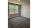 Comfortable bedroom featuring a large window with a wooded view and a double door closet at 60 Lemon Drop Ln, Franklinton, NC 27525