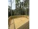 Large wooden deck with railing, ideal for outdoor entertaining and enjoying the surrounding wooded scenery at 60 Lemon Drop Ln, Franklinton, NC 27525