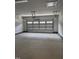 Clean, empty garage with modern door and opener, ready for parking and storage solutions at 60 Lemon Drop Ln, Franklinton, NC 27525
