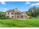 Large backyard with well-manicured lawn, brick house with outdoor patio, screened porch, and nature at 6366 Lineberry Rd, Liberty, NC 27298