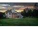 Back exterior view of a beautiful home with a big backyard, screened porch and a sunset background at 6366 Lineberry Rd, Liberty, NC 27298